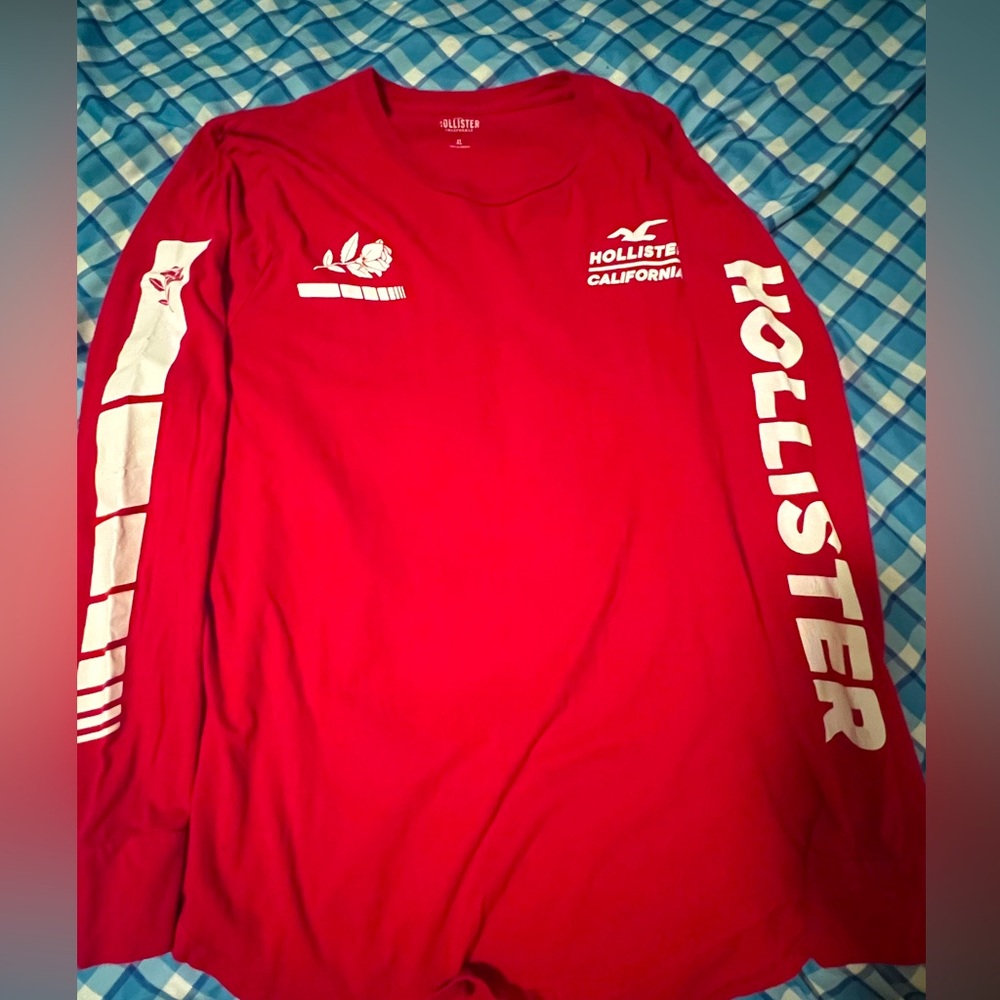 Red polyester long sleeve hollister tee rose design. Size Xl
